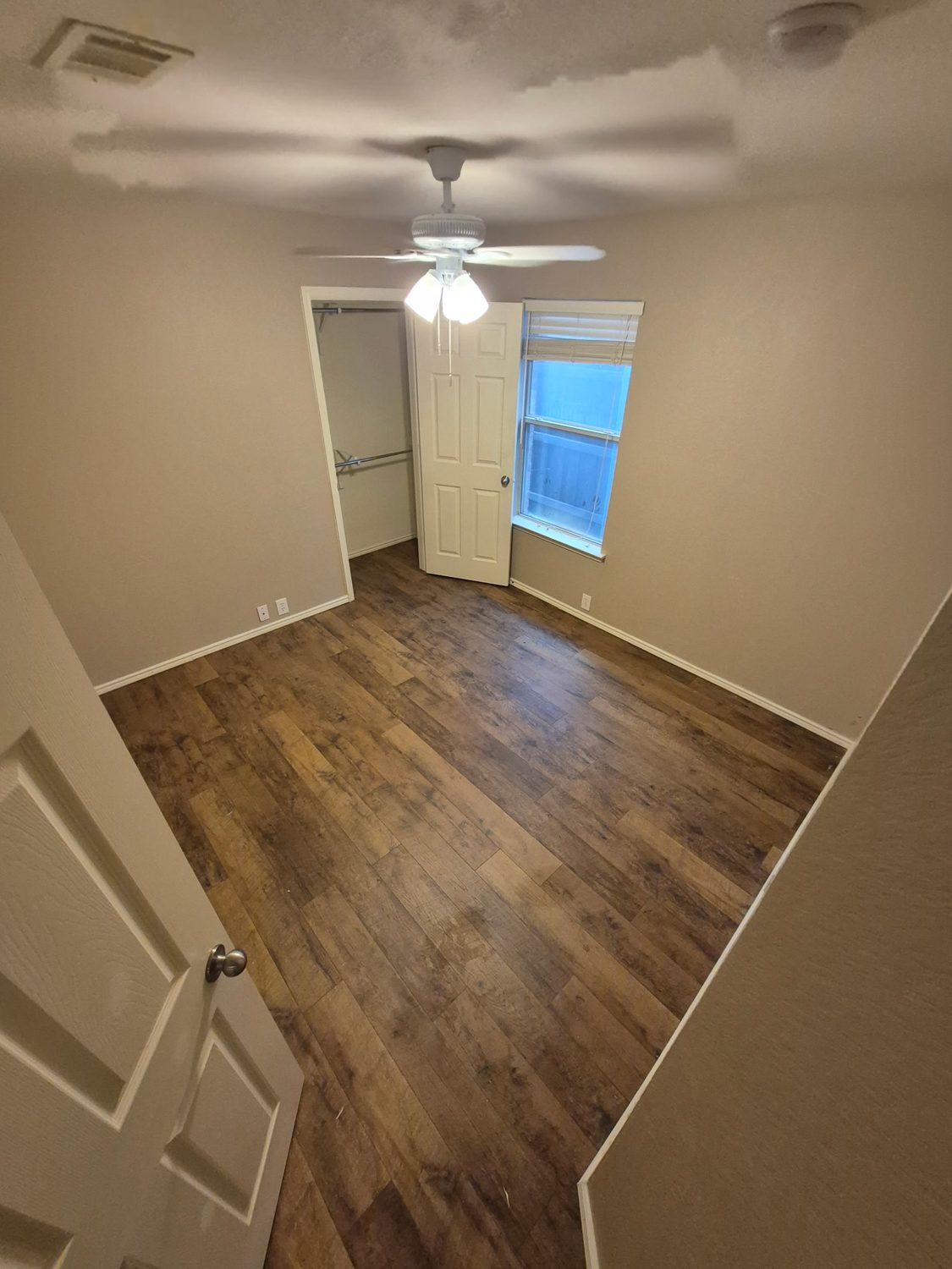 Bedroom with new wood-look flooring after