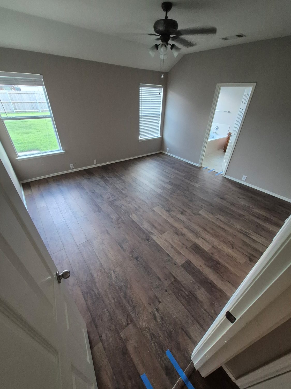 New vinyl-plank flooring in a bright McKinney master bedroom